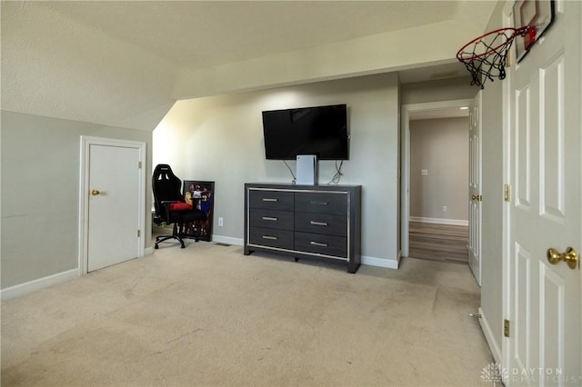 carpeted bedroom featuring a textured ceiling and vaulted ceiling