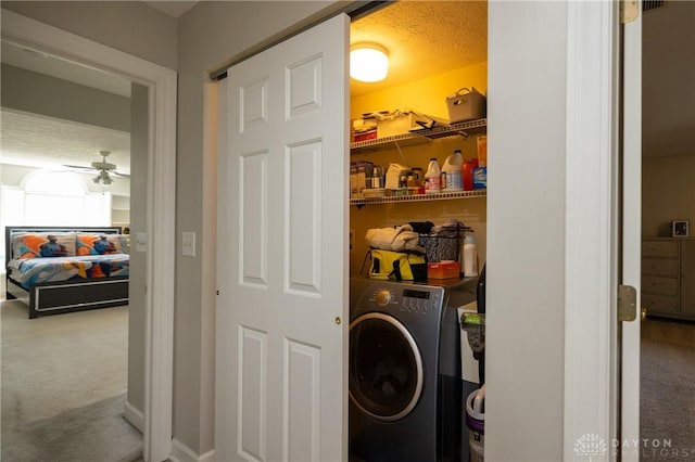 washroom featuring ceiling fan, washer / clothes dryer, carpet floors, and a textured ceiling