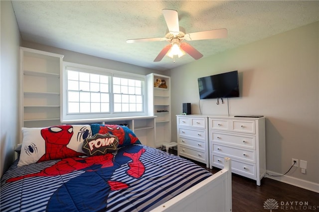 bedroom with ceiling fan, dark hardwood / wood-style flooring, and a textured ceiling