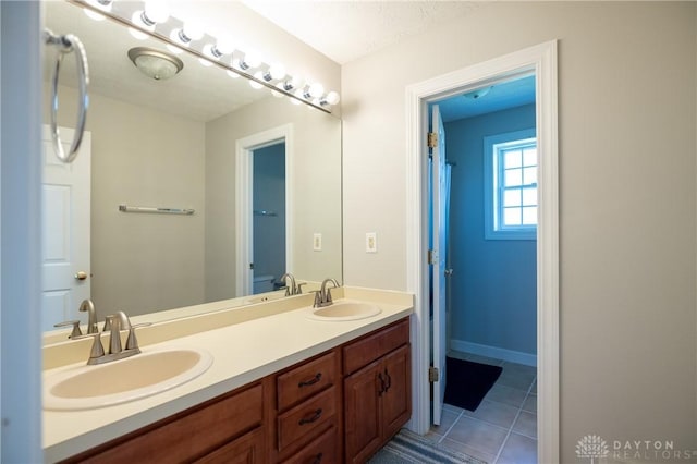 bathroom featuring a textured ceiling, tile patterned floors, and vanity