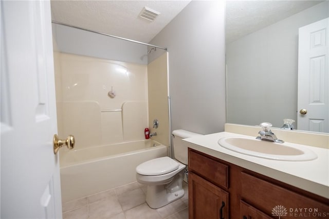 full bathroom featuring tile patterned flooring, toilet, tub / shower combination, vanity, and a textured ceiling