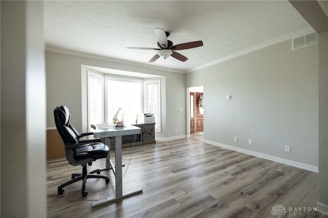 office with ceiling fan, ornamental molding, and light hardwood / wood-style floors