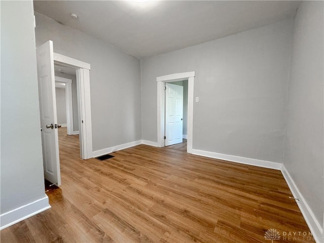 spare room with light hardwood / wood-style floors