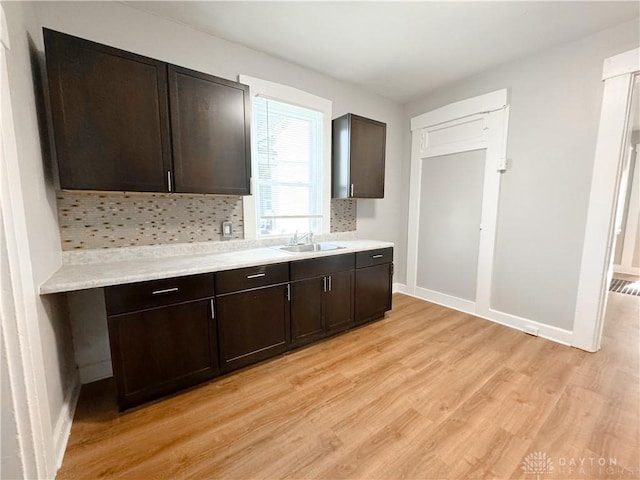 kitchen featuring dark brown cabinetry and sink