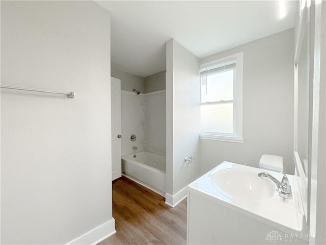 bathroom featuring vanity, hardwood / wood-style floors, and  shower combination