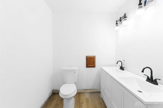 bathroom with vanity, hardwood / wood-style flooring, and toilet