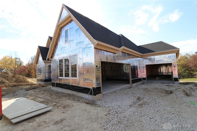 view of side of property with a carport