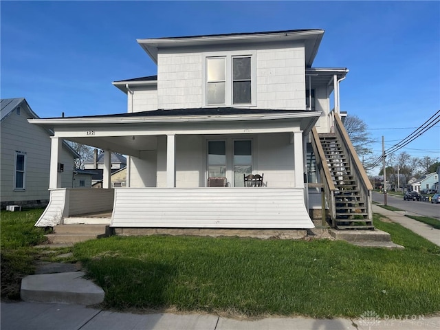 view of front of property with a porch and a front lawn