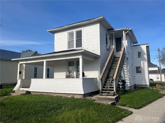 view of front of house featuring a porch and a front lawn