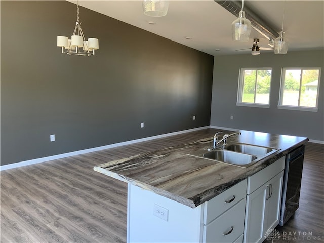 kitchen with dishwashing machine, pendant lighting, sink, a kitchen island with sink, and dark wood-type flooring