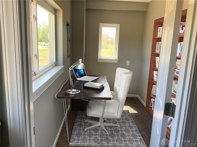 office featuring dark carpet and baseboards