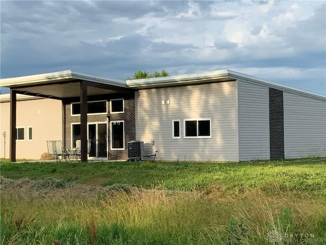 back of property featuring brick siding