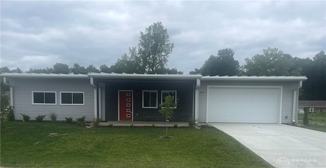 ranch-style house with a garage and a front yard