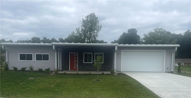 ranch-style house with concrete driveway, a front lawn, and an attached garage