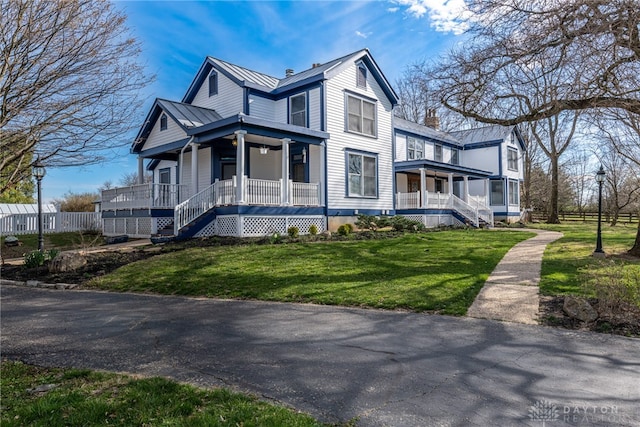 view of home's exterior with a porch and a lawn