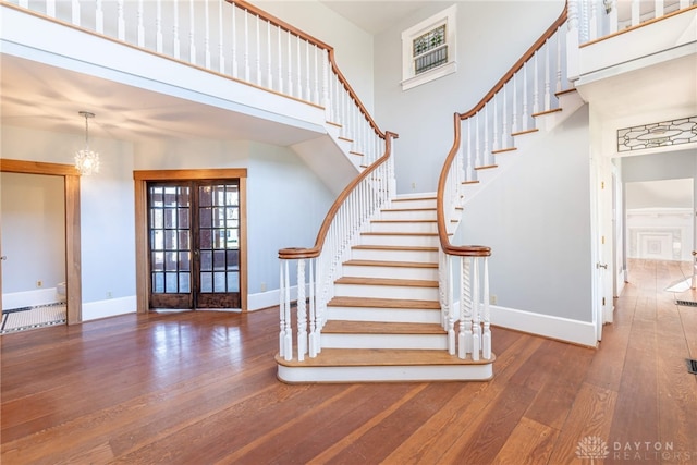 2696 Wilmington Rd, Lebanon, OH 45036 - stairway featuring hardwood / wood-style flooring, a high ceiling, french doors, and baseboards