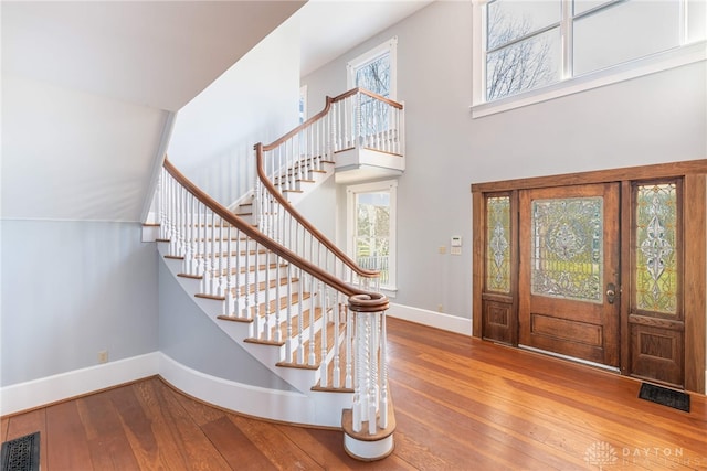 2696 Wilmington Rd, Lebanon, OH 45036 - entryway featuring visible vents, a towering ceiling, baseboards, stairs, and hardwood / wood-style flooring