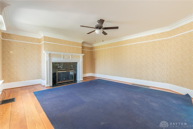 2696 Wilmington Rd, Lebanon, OH 45036 - unfurnished living room with wallpapered walls, a ceiling fan, wood-type flooring, crown molding, and a fireplace