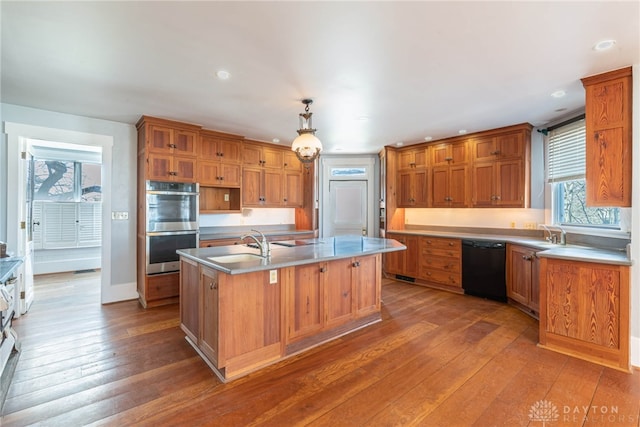 2696 Wilmington Rd, Lebanon, OH 45036 - kitchen featuring dishwasher, a center island with sink, stainless steel double oven, and hardwood / wood-style flooring