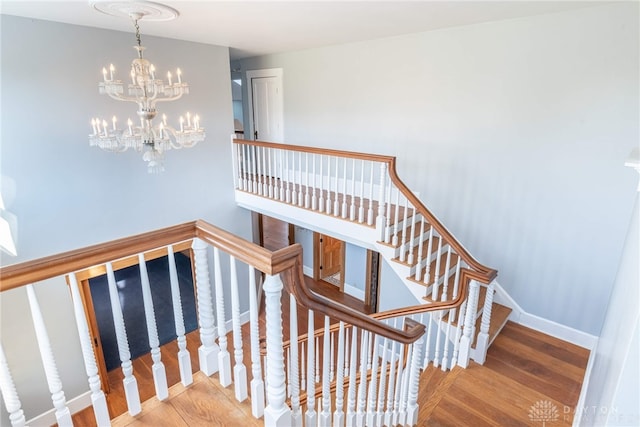 2696 Wilmington Rd, Lebanon, OH 45036 - staircase with baseboards, wood finished floors, and a notable chandelier