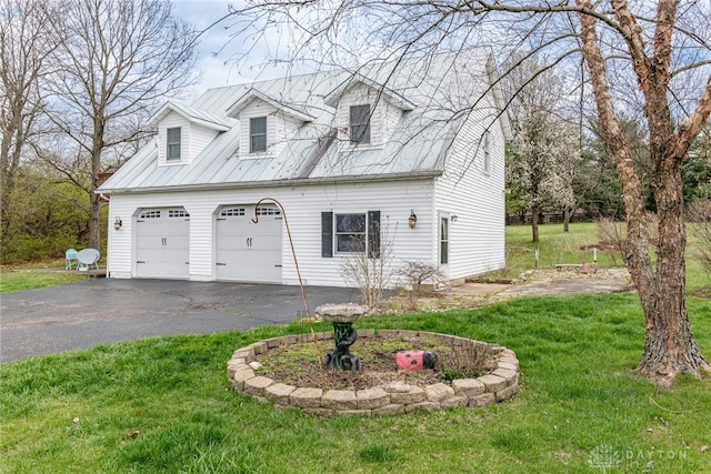 2696 Wilmington Rd, Lebanon, OH 45036 - view of front of home featuring a garage, driveway, a front yard, and metal roof