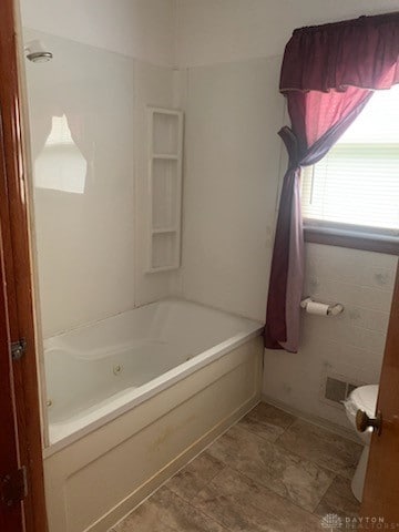 bathroom with tub / shower combination and tile patterned floors