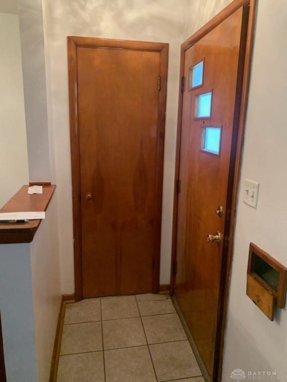 corridor with light tile patterned floors