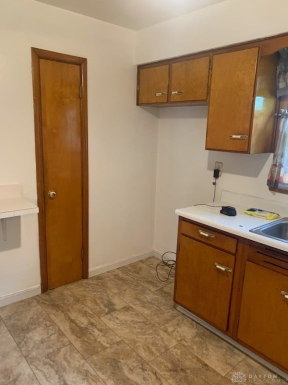 kitchen featuring sink and light tile patterned floors