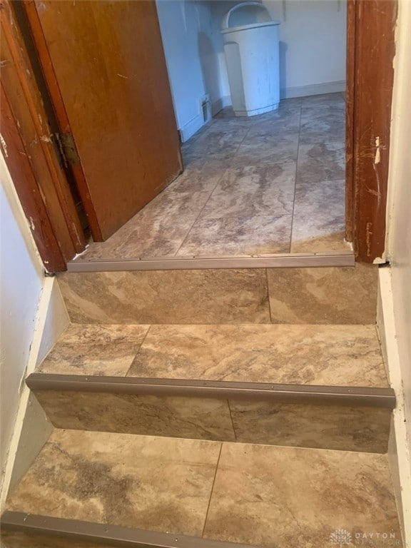 stairway with tile patterned flooring