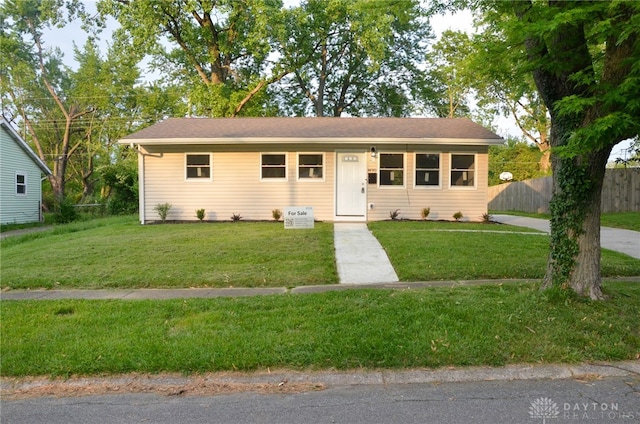 ranch-style home featuring a front yard