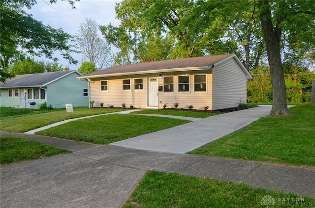 ranch-style house featuring a front lawn