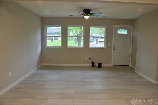 foyer entrance with ceiling fan