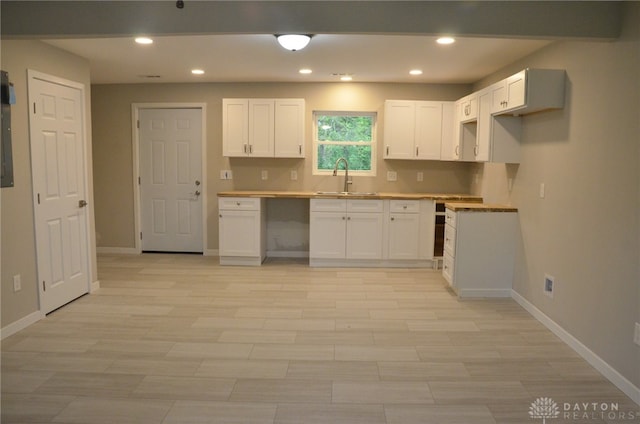 kitchen featuring sink and white cabinetry