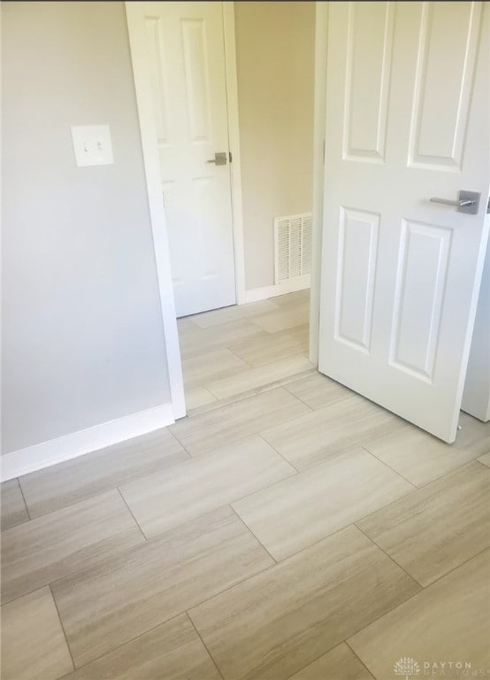 hallway with light hardwood / wood-style flooring