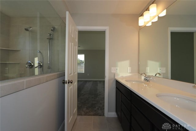 bathroom featuring tile patterned floors, walk in shower, a sink, and double vanity