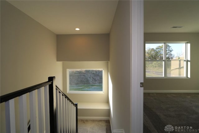 staircase with carpet floors, recessed lighting, visible vents, and baseboards