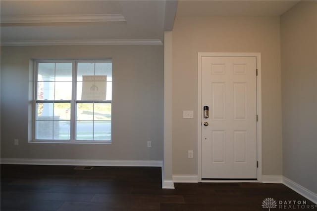 foyer with visible vents, baseboards, dark wood-style flooring, and ornamental molding