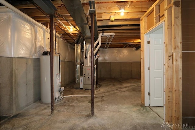 unfinished below grade area featuring gas water heater and heating unit