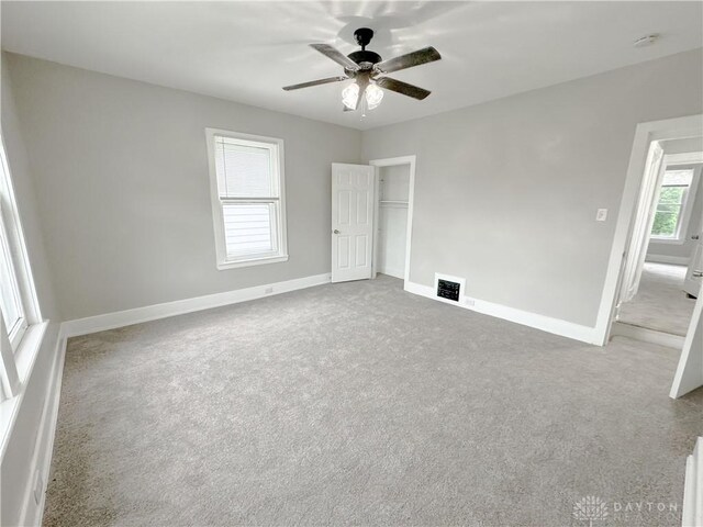 unfurnished bedroom with carpet floors, baseboards, visible vents, and a closet