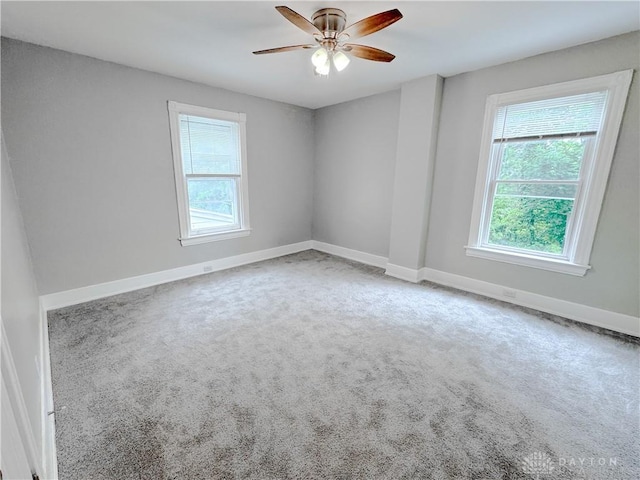 spare room with carpet flooring, a ceiling fan, and baseboards