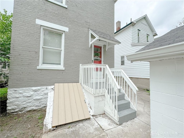 entrance to property featuring brick siding