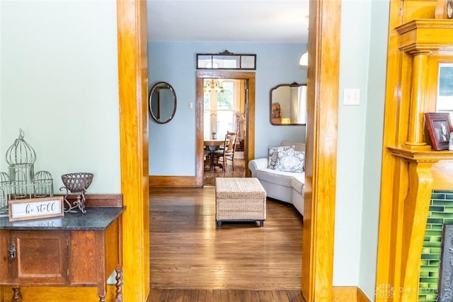 living area featuring wood finished floors and baseboards