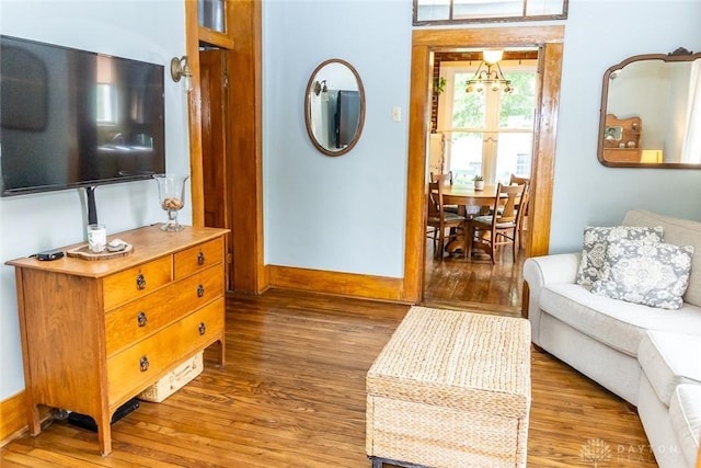 living area with light wood finished floors and baseboards