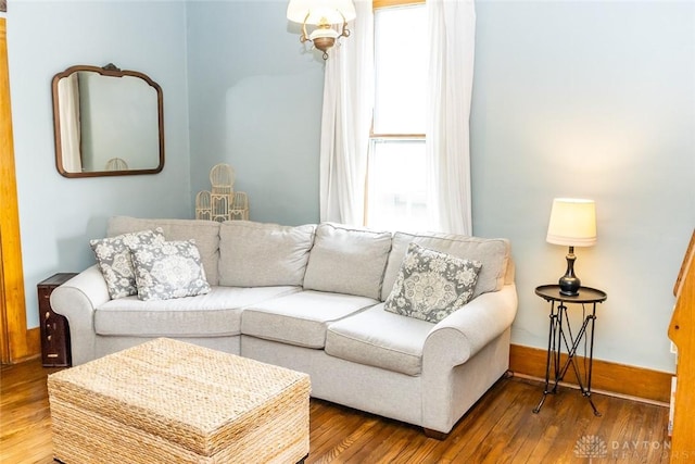 living area featuring a healthy amount of sunlight, baseboards, and hardwood / wood-style floors