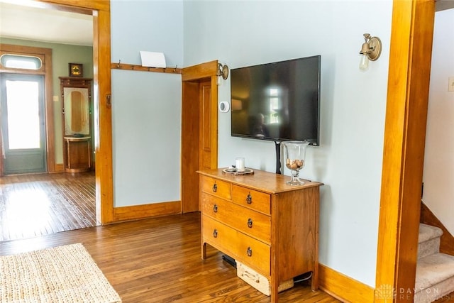 interior space featuring stairway, wood finished floors, and baseboards