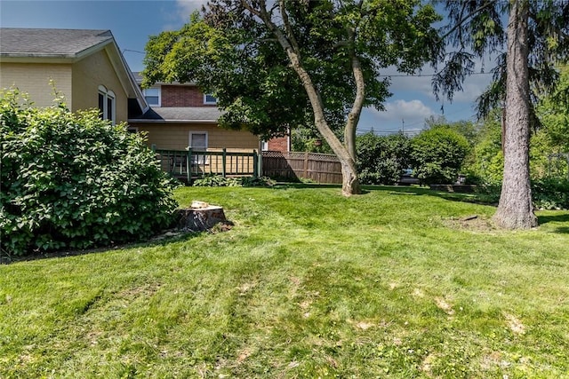 view of yard featuring a wooden deck and fence