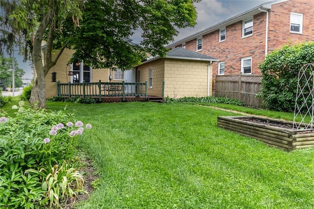 view of yard with fence and a wooden deck