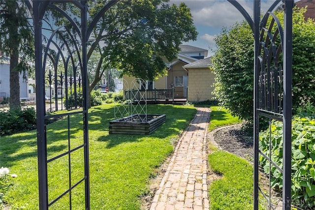 view of home's community with a lawn and a wooden deck