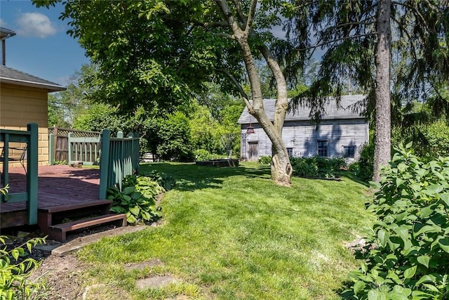 view of yard with fence and a wooden deck