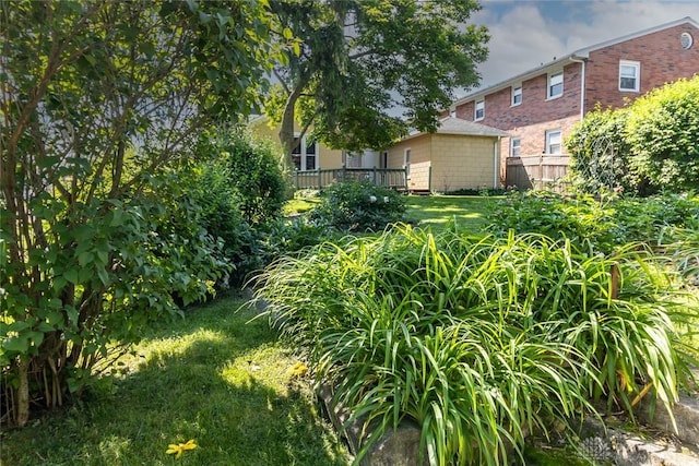 view of yard with fence and a wooden deck